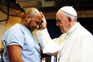 Pope Francis blesses a prisoner as he visits the Curran-Fromhold Correctional Facility in Philadelphia Sept. 27. (CNS photo/Paul Haring) See POPE-PRISON Sept. 27, 2015.